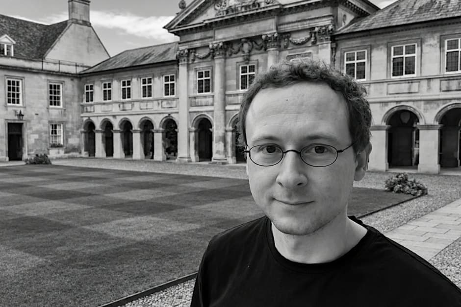 Portrait of Nathan Cofnas in a college quad